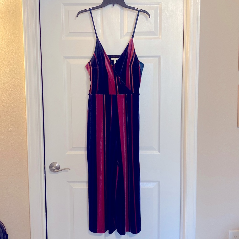 Never worn v neck velvet jumpsuit. Size Large. Multi colored.